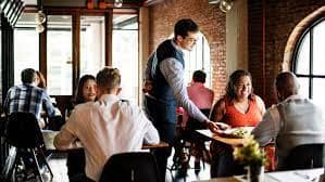 Restaurant waiter serving food