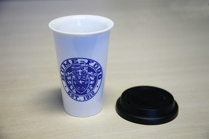 Promotional Coffee travel cup with a school logo